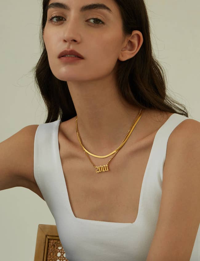 a model wearing a birth year necklace for 2001