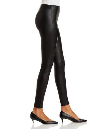 side of a model wearing black leather skinny pants with pumps