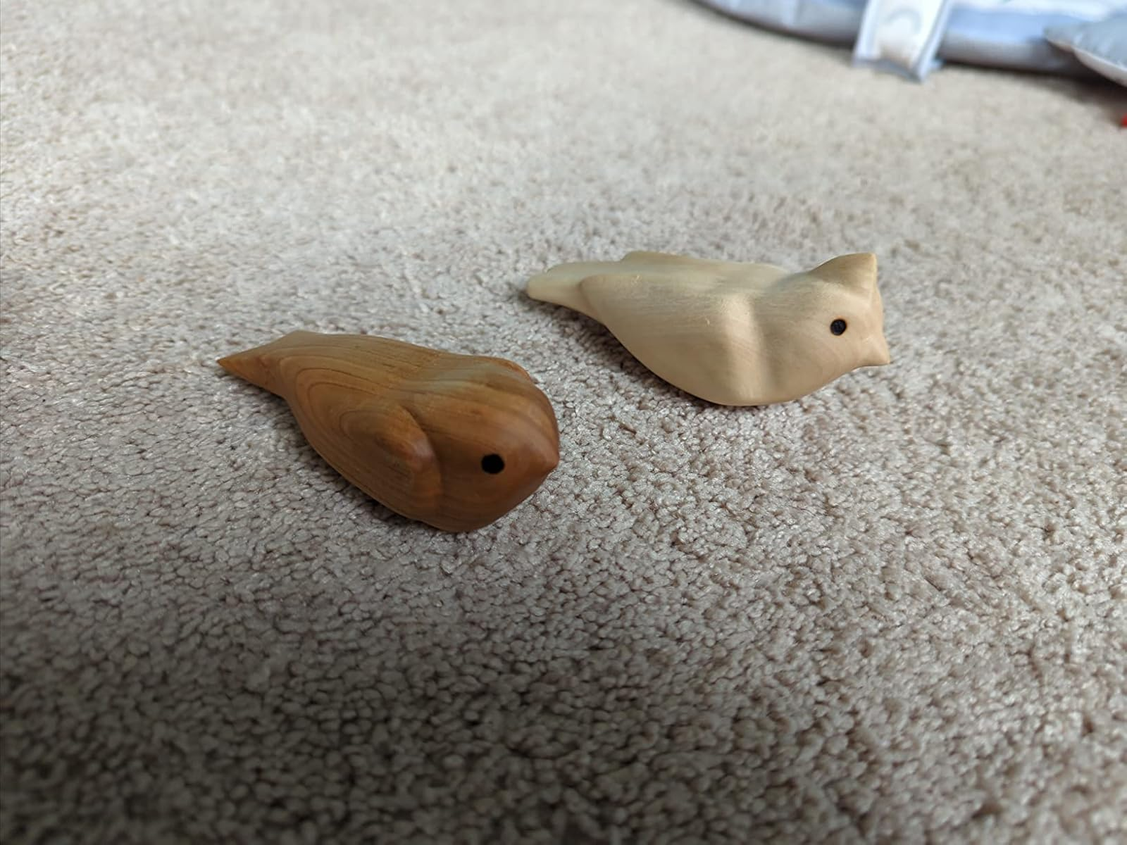 Two small, carved woody  vertebrate  figures