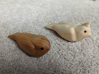 Two small, carved woody vertebrate figures