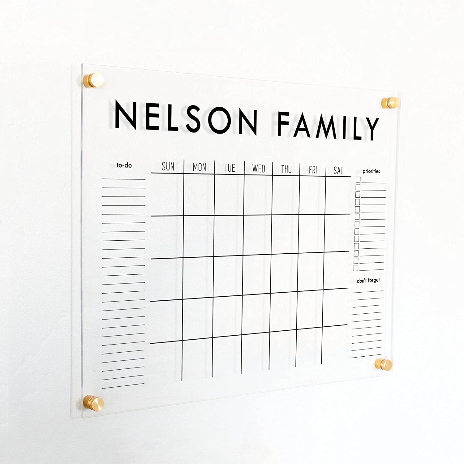 the calendar on the wall reads nelson family on the top