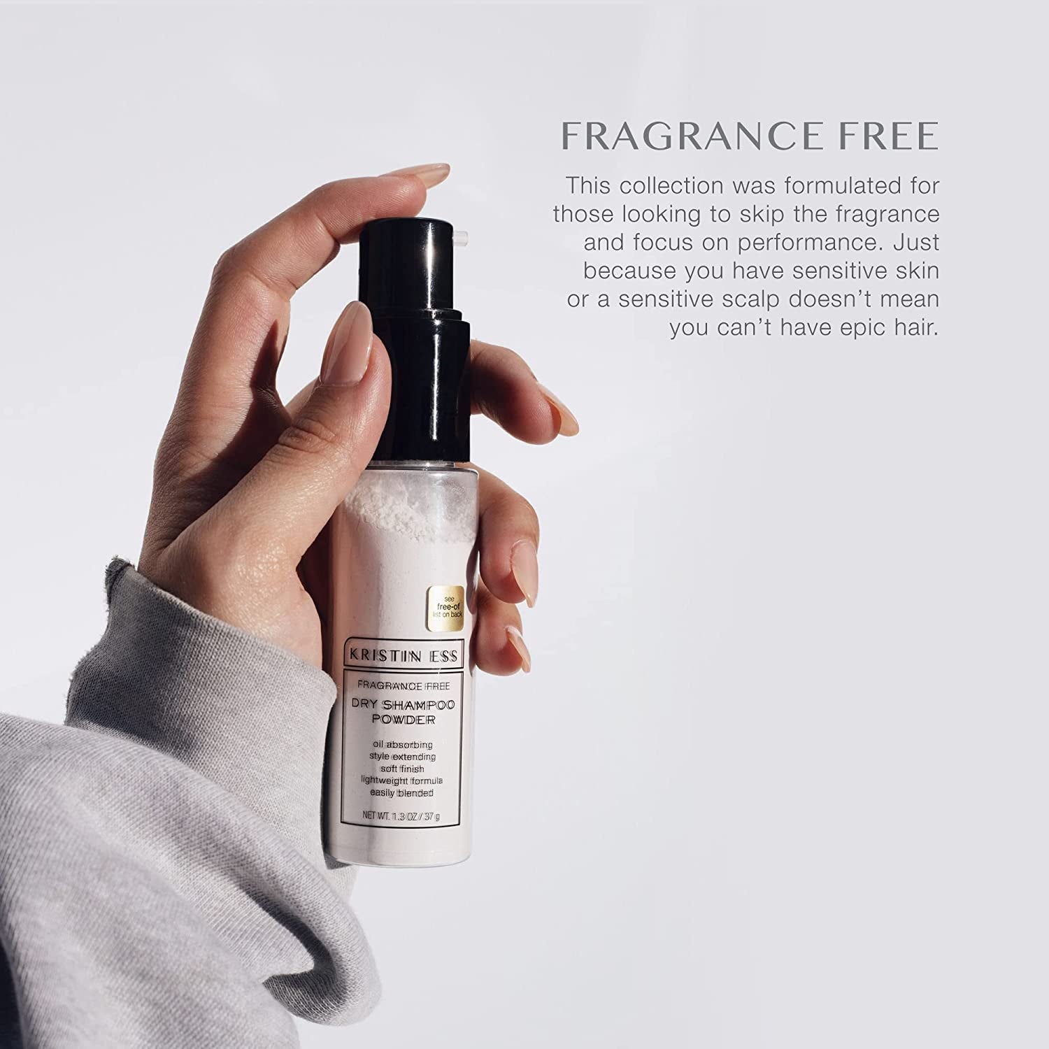 model's hand spraying the dry shampoo powder