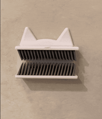 a gif of a reviewer using the hair catcher to trap hair 