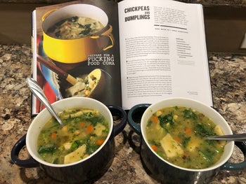 two bowls of soup in front of the cookbook that is open to the soup recipe page
