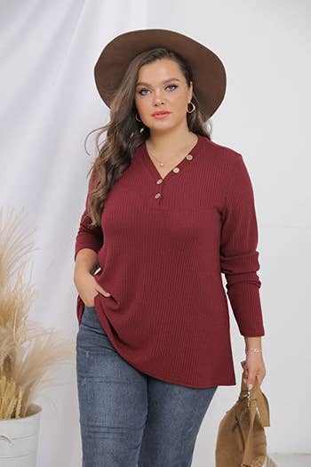 a plus size model wearing the wine red henley