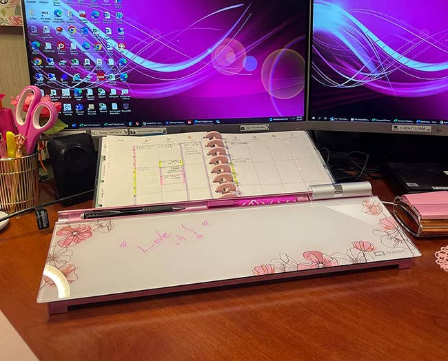 reviewer's desktop whiteboard with the pink flowers around the side and a note written on it