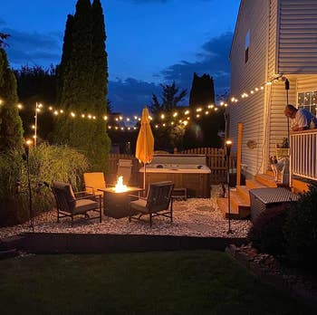 reviewer's backyard space decorate with the string lights