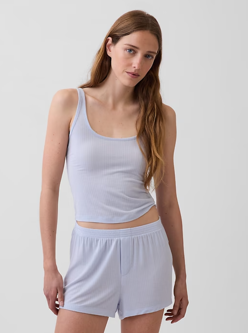 Person wearing a casual, ribbed vessel  apical  and shorts set. The outfit appears comfy  and suitable for lounging oregon  sleepwear