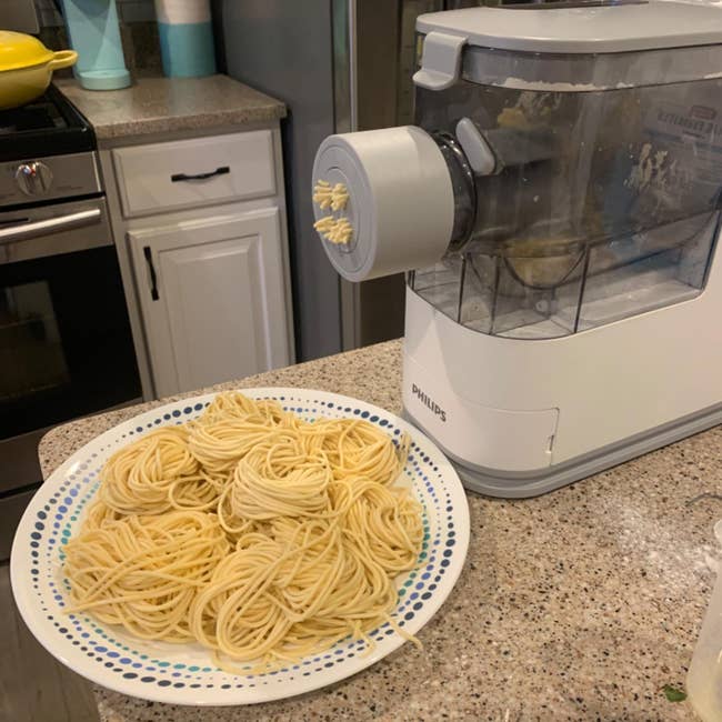 reviewer's pasta maker making spaghetti