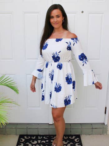 reviewer wearing white and blue dress