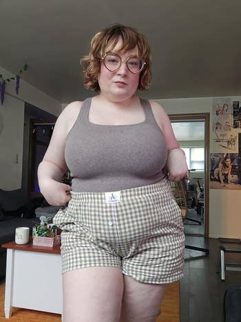 A reviewer wearing the shorts with a casual top