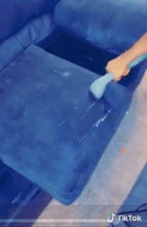 gif of reviewer using the cleaner to make their couch cushion look brand new