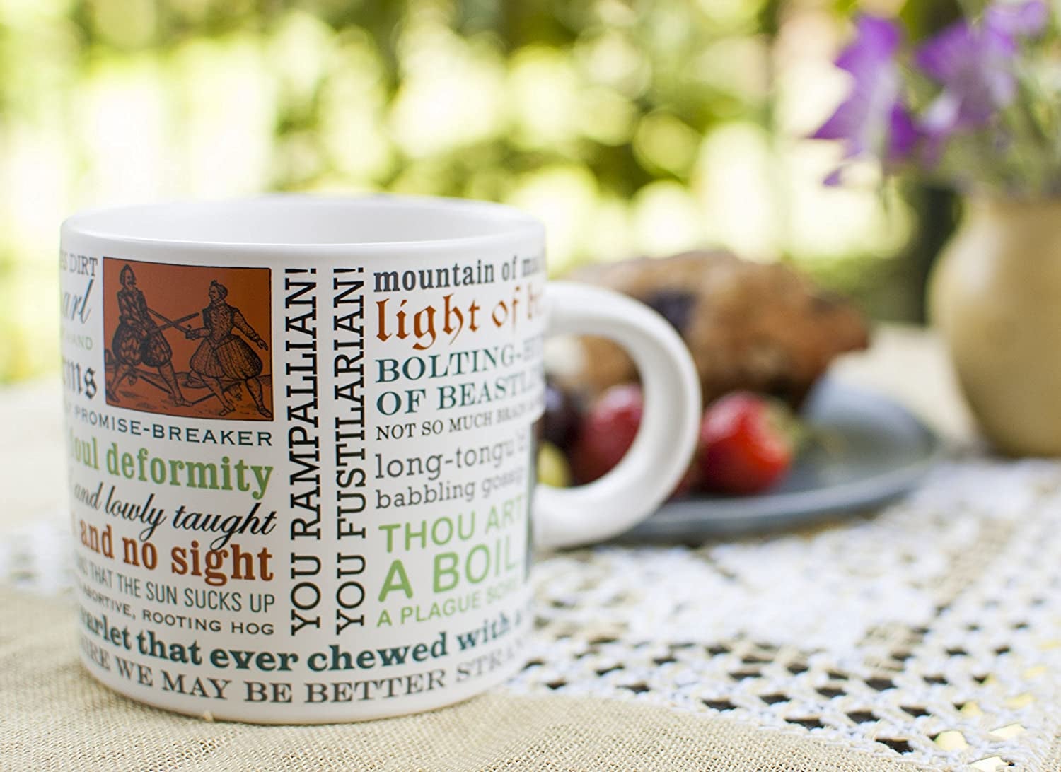 the Shakespearean insults mug with different text blurbs on it sitting on a table