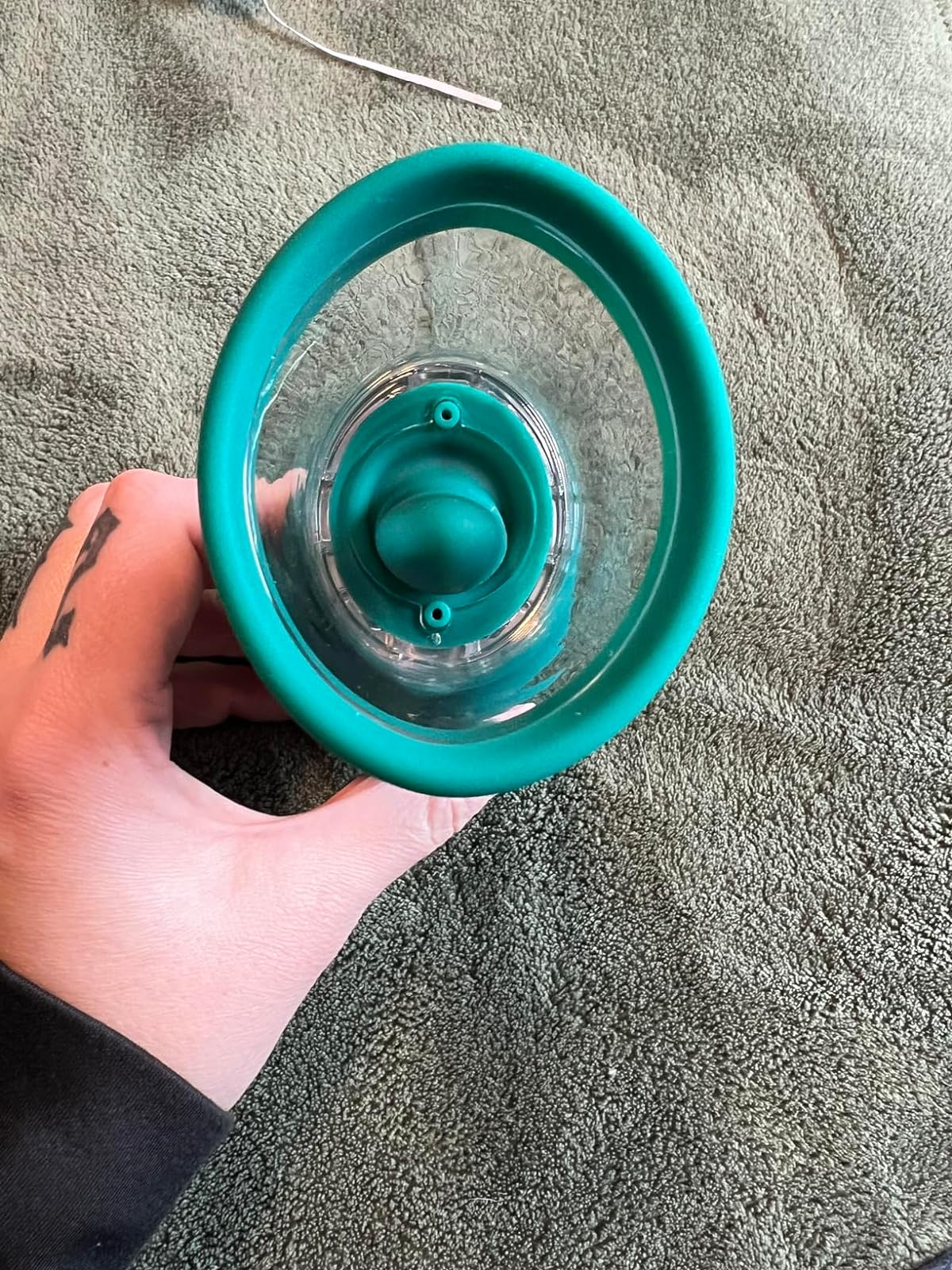 Reviewer showing transparent suction cup with fluttering tongue inside