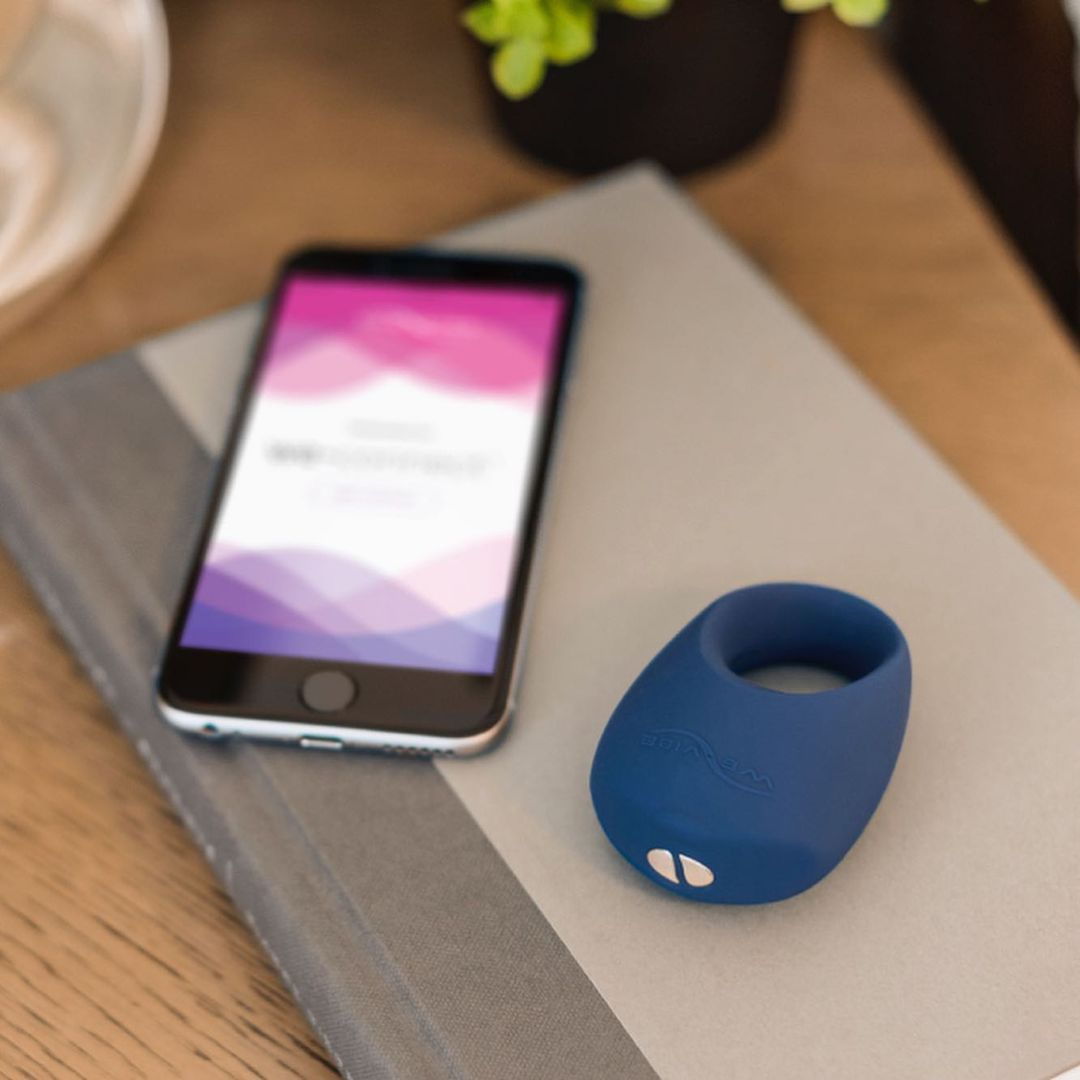 Cock ring next to cell phone on nightstand