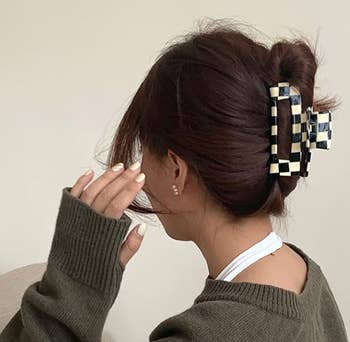 person wearing the clip to secure a twist on their head. it has a hollow center.
