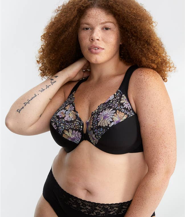 a model wearing the black floral bra