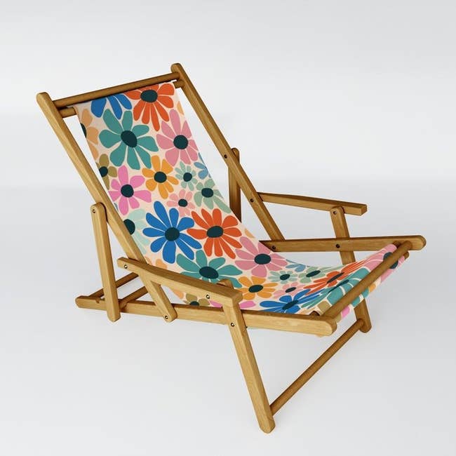 the chair featuring a wooden fame and floral-printed seat and back 