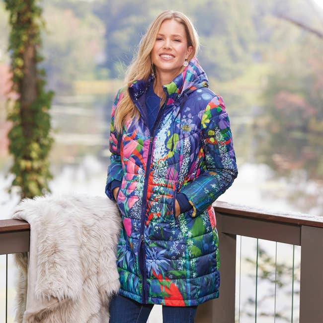 a model wearing a quilted down coat featuring a multicolor floral print 