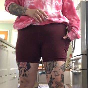 Reviewer wearing the burgundy shorts with the 5 inch length