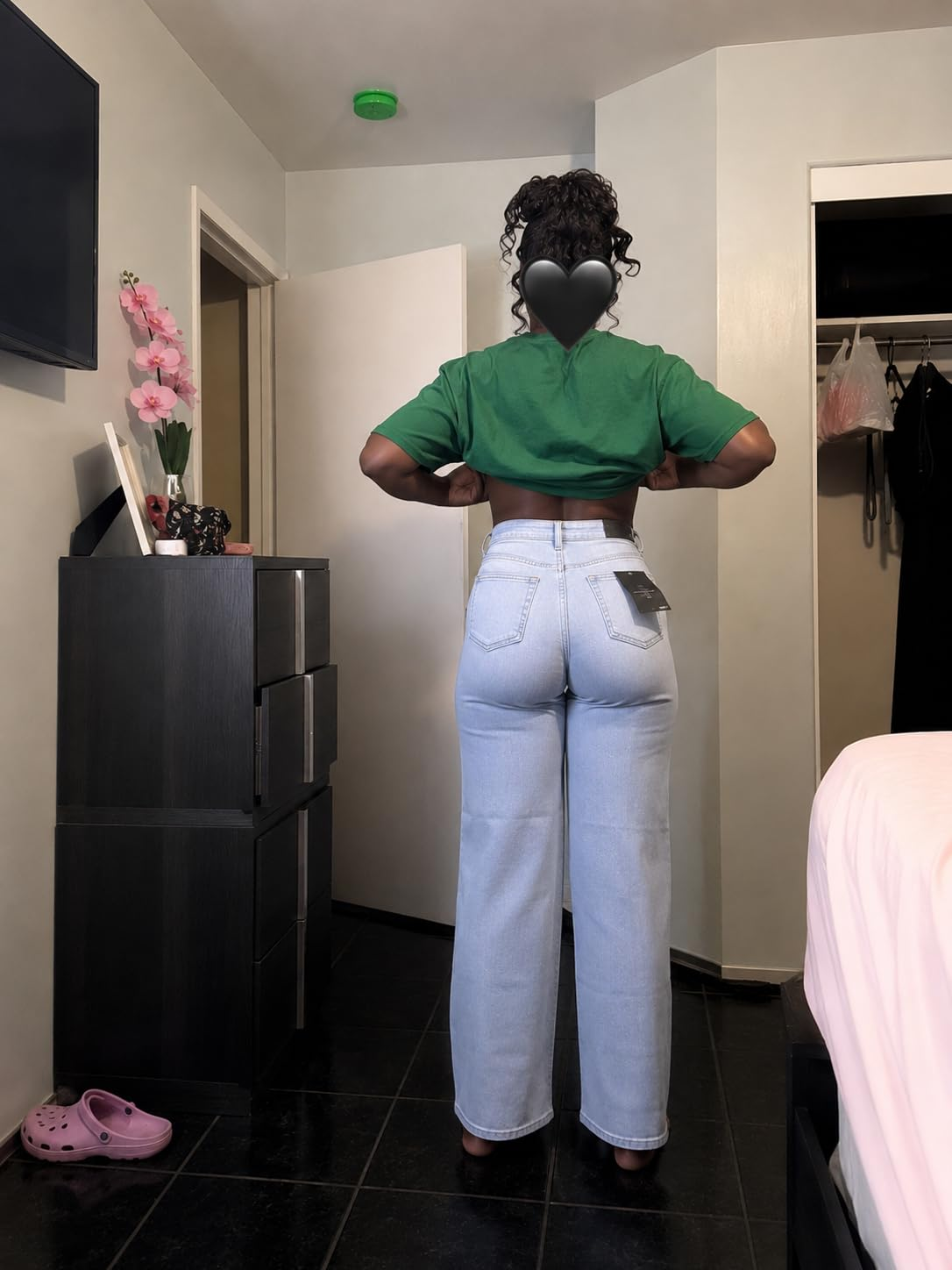 Person successful  a cropped apical  and high-waisted jeans displays the acceptable  of the jeans successful  a country   setting