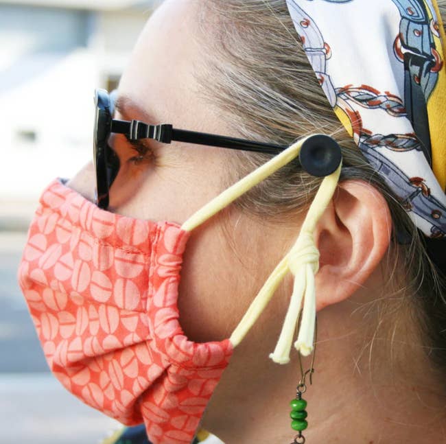 person wearing a mask attached to the ear savers on their glasses
