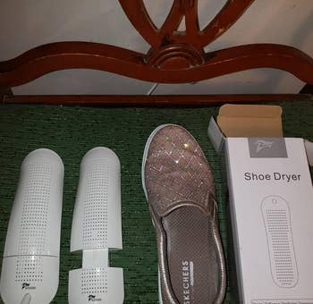 a reviewer photo of the shoe dryer units next to a show 