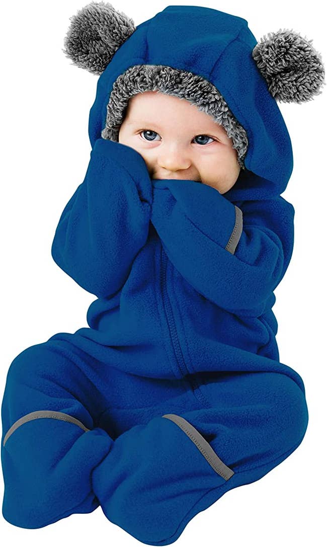 a product shot of a baby wearing the suit in blue