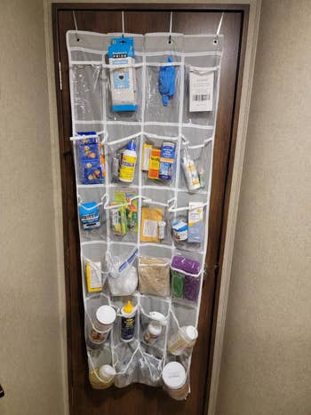 Over-the-door organizer holding assorted  household   items similar  cleaning supplies, snacks, and toiletries, showcasing retention  solutions