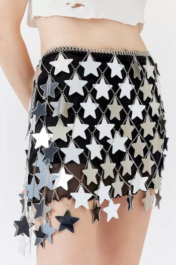 model wearing a star-patterned chain skirt