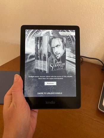 another reviewer holding the Kindle showing the black and white screen