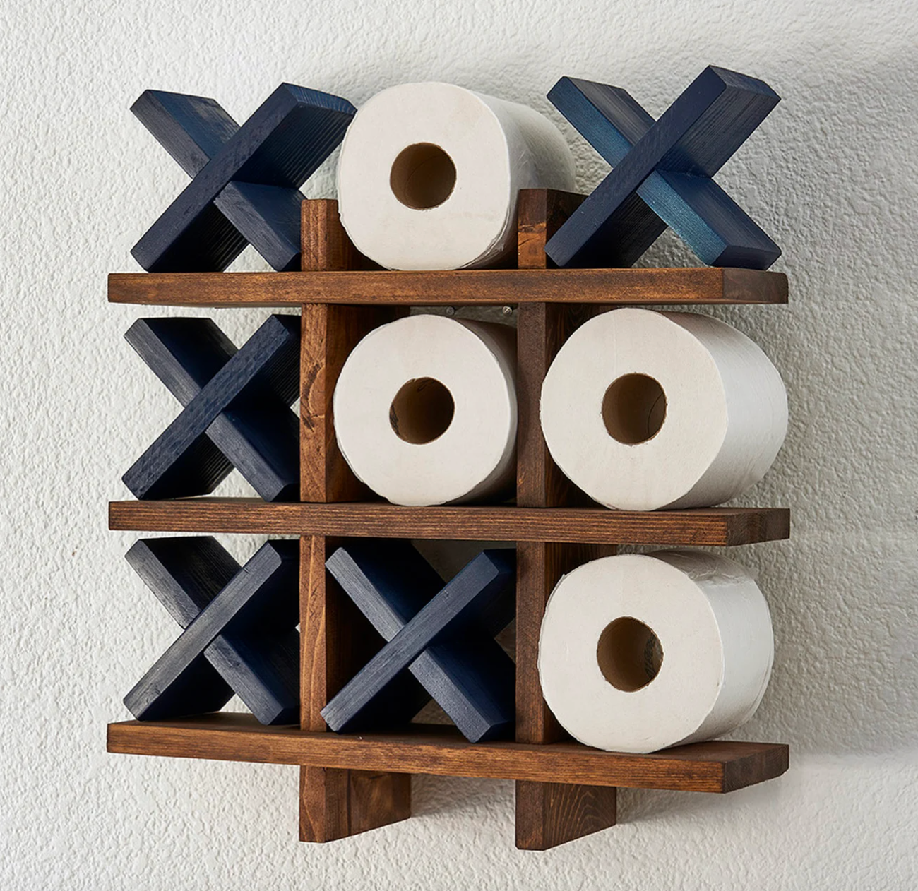 navy blue tic tac toilet roll holder mounted on a wall