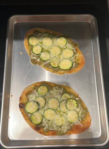 Naan mini pizzas with mozzarella, pesto, and sliced zucchini made with Hungryroot groceries