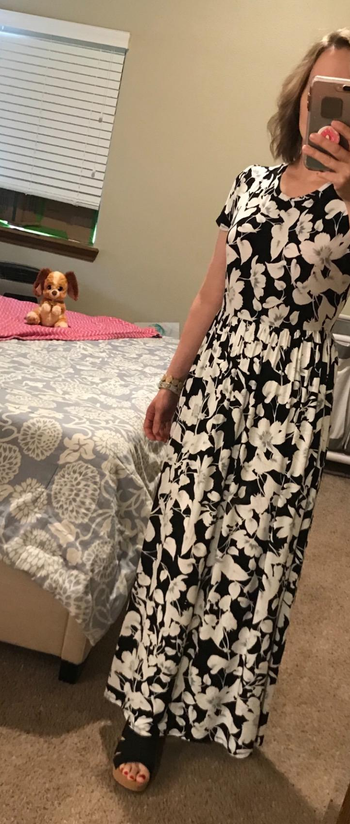 a reviewer wearing the dress in a black and white floral print