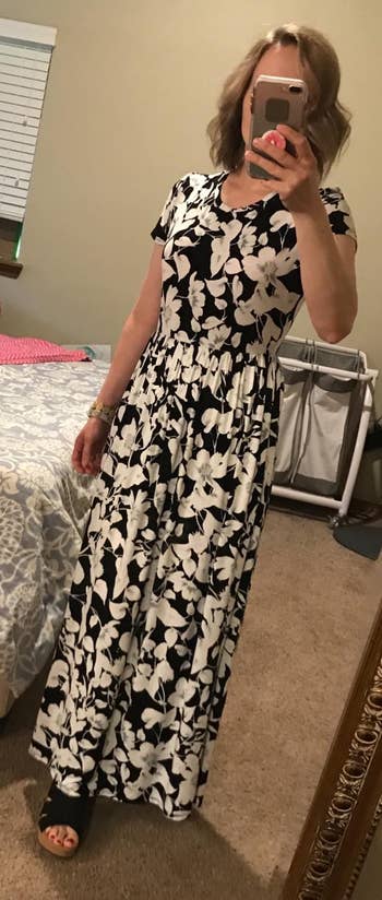 a reviewer wearing the dress in a black and white floral print 