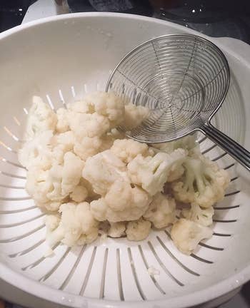 reviewer photo of the spider placing blanched cauliflower florets into a colander