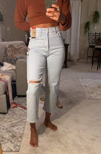reviewer wearing the jeans in light wash