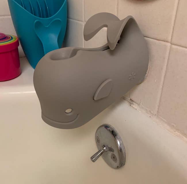reviewer's gray whale spout cover on a bathtub facuet