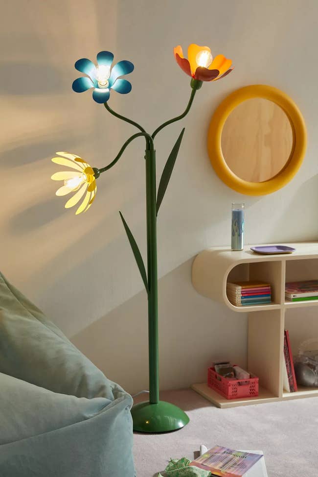 A decorative floor lamp with three flower-shaped lights