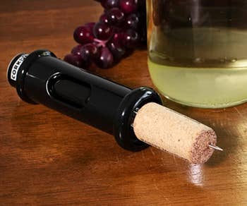 The small black device with a used cork in it 