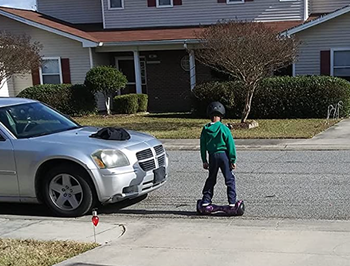 A reviewer riding on the hoverboard