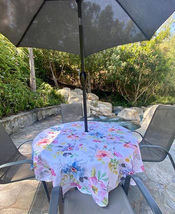reviewer photo of the round floral tablecloth on a picnic table