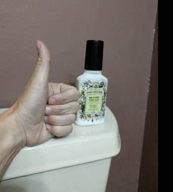 reviewer image of bottle sitting on toilet