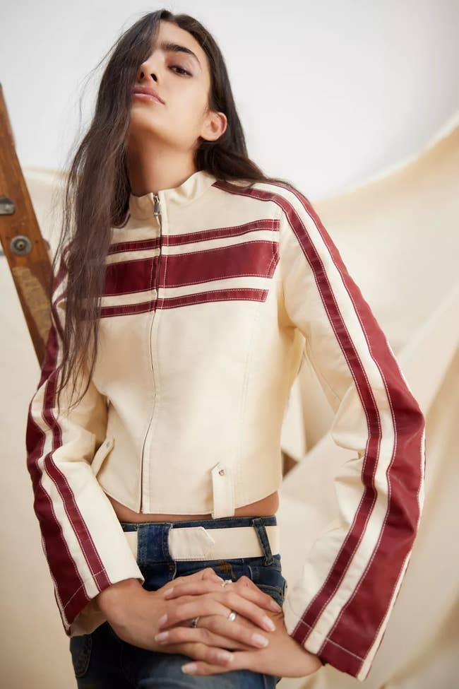 model in a cropped white jacket with red stripes
