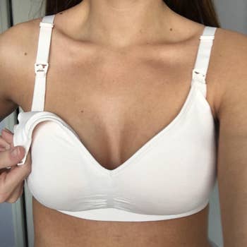 a close up of a reviewer wearing the white bra