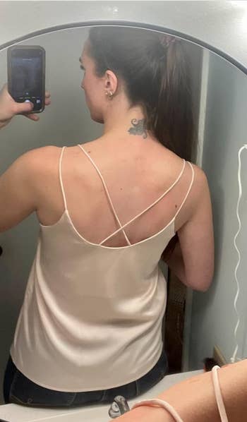 Person in a strappy top taking a mirror selfie, showcasing the back fit and design