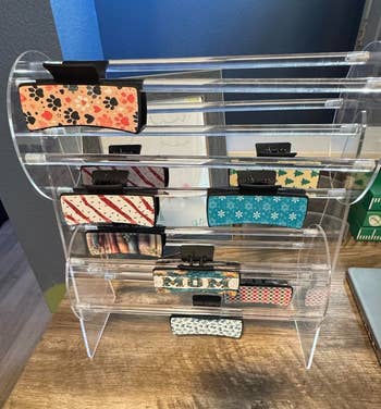hair claw clips displayed successful a wide stand, featuring assorted patterns specified arsenic florals and stripes, acceptable connected a woody surface
