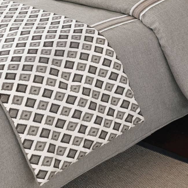 Grey diamond bed runner on a grey bed
