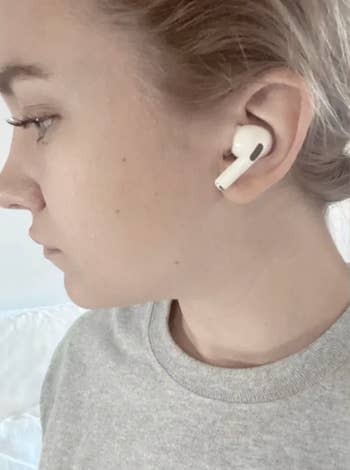 Emma wearing airpods