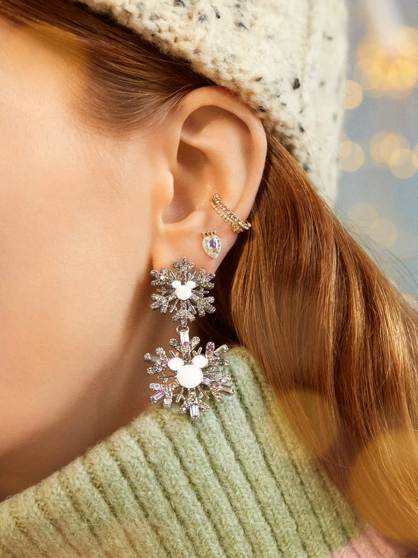 model in sparkly drop earrings with two snowflakes each with mickey head silhouette in the center